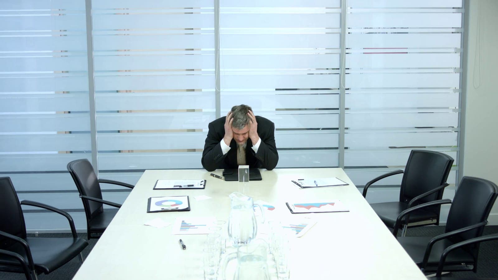 Frustrated business owner sitting alone after a system outage