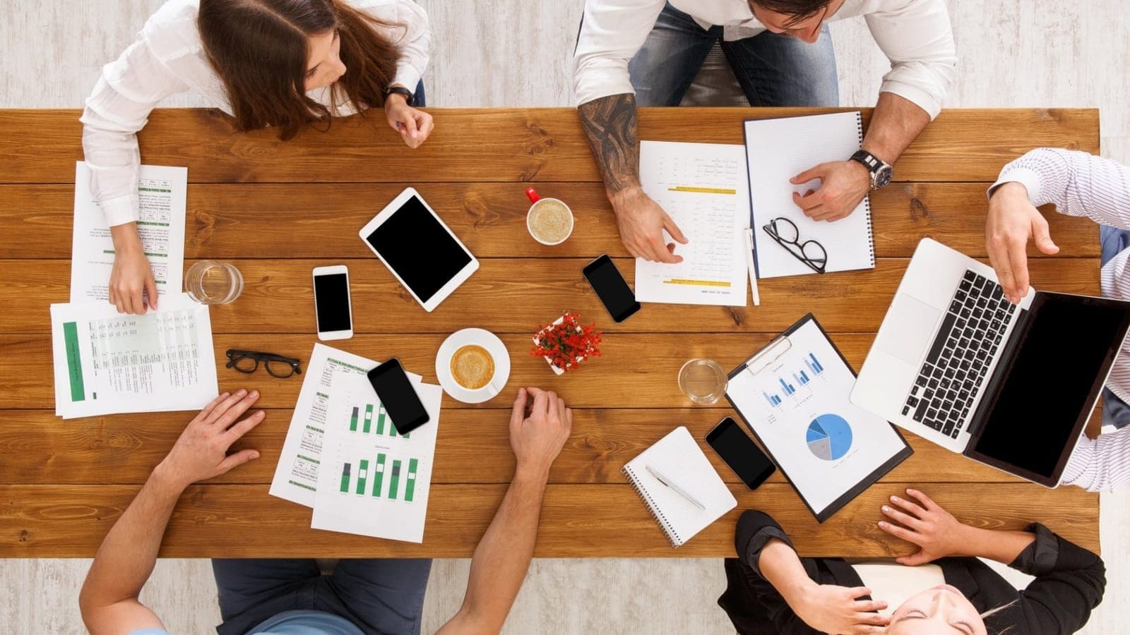 Team reviewing proposals together across a meeting desk