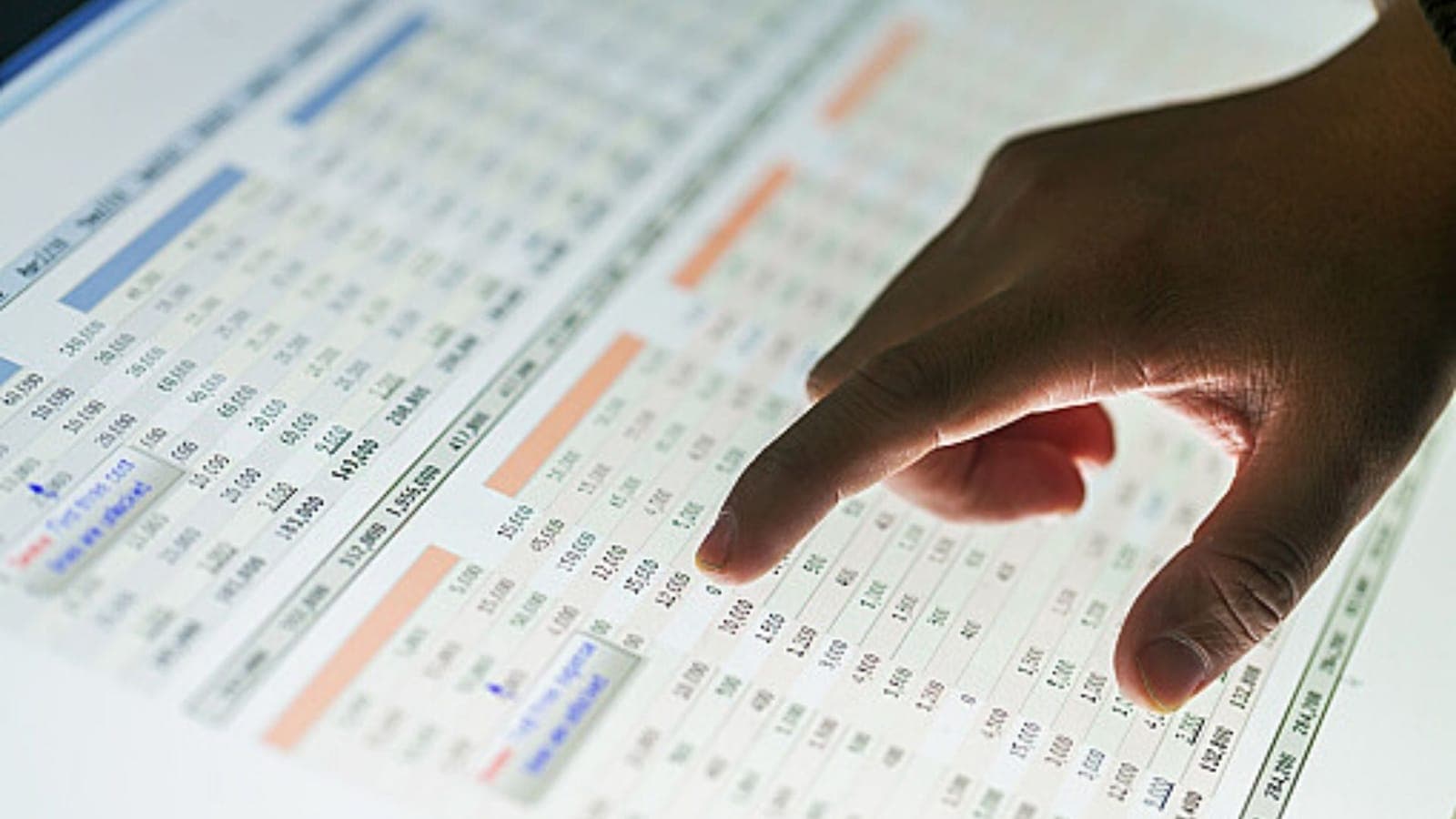 Person reviewing a pricing spreadsheet on screen at a desk