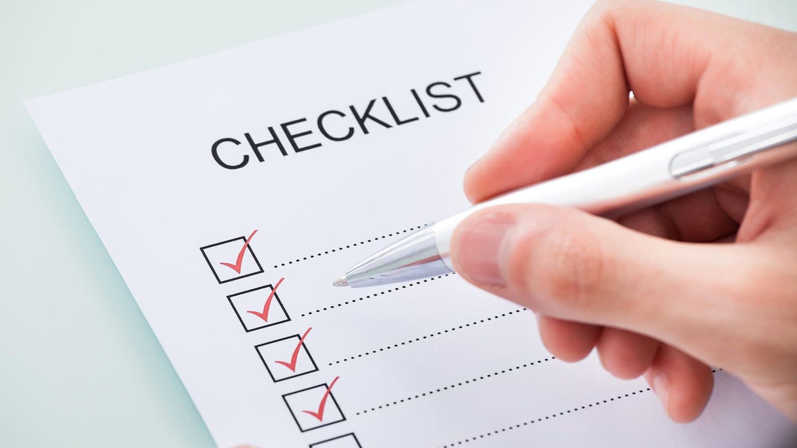 Checklist being marked complete with a red pen